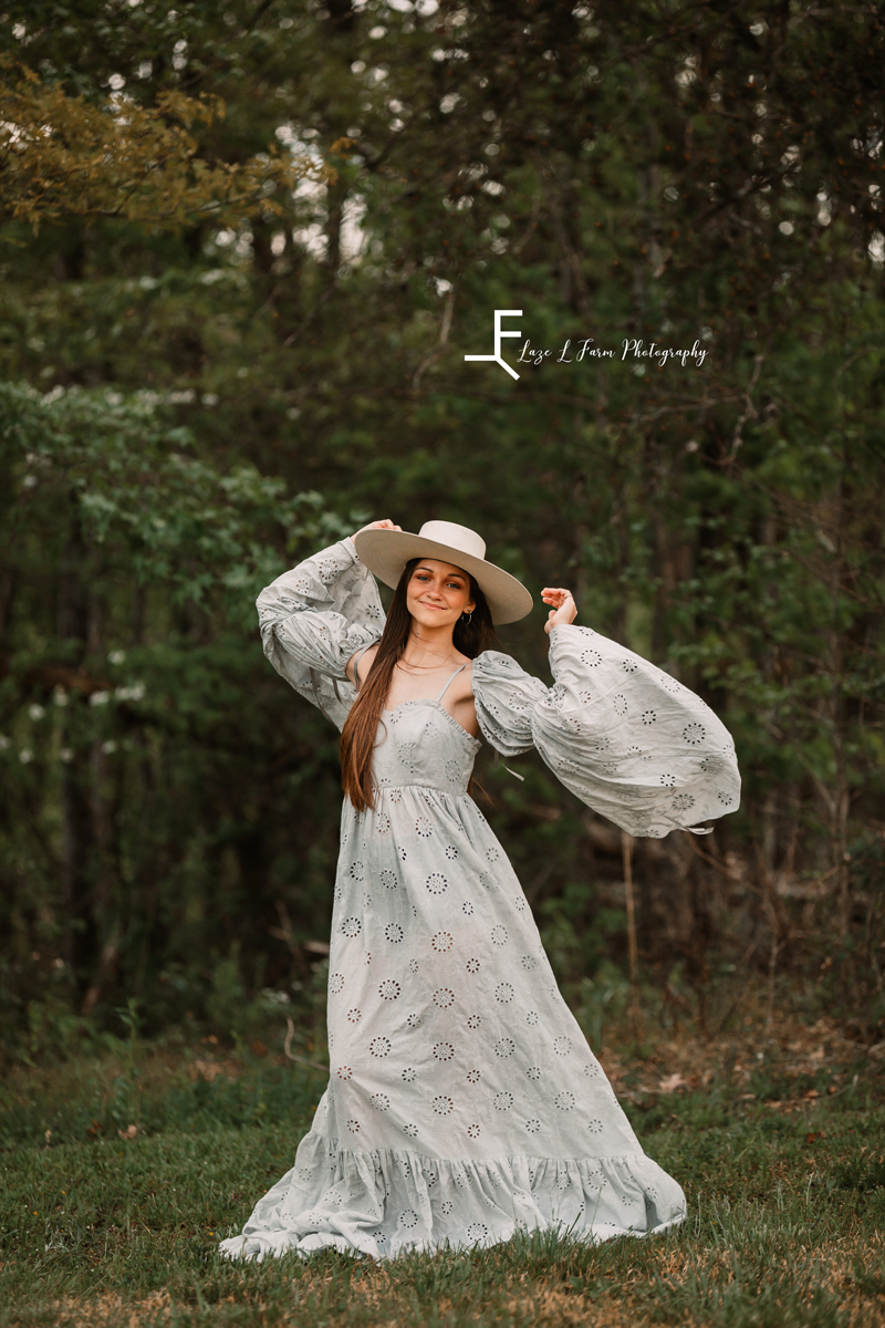 Laze L Farm Photography | Fairytale Dress Photoshoot | Taylorsville NC | holding the edges of a hat