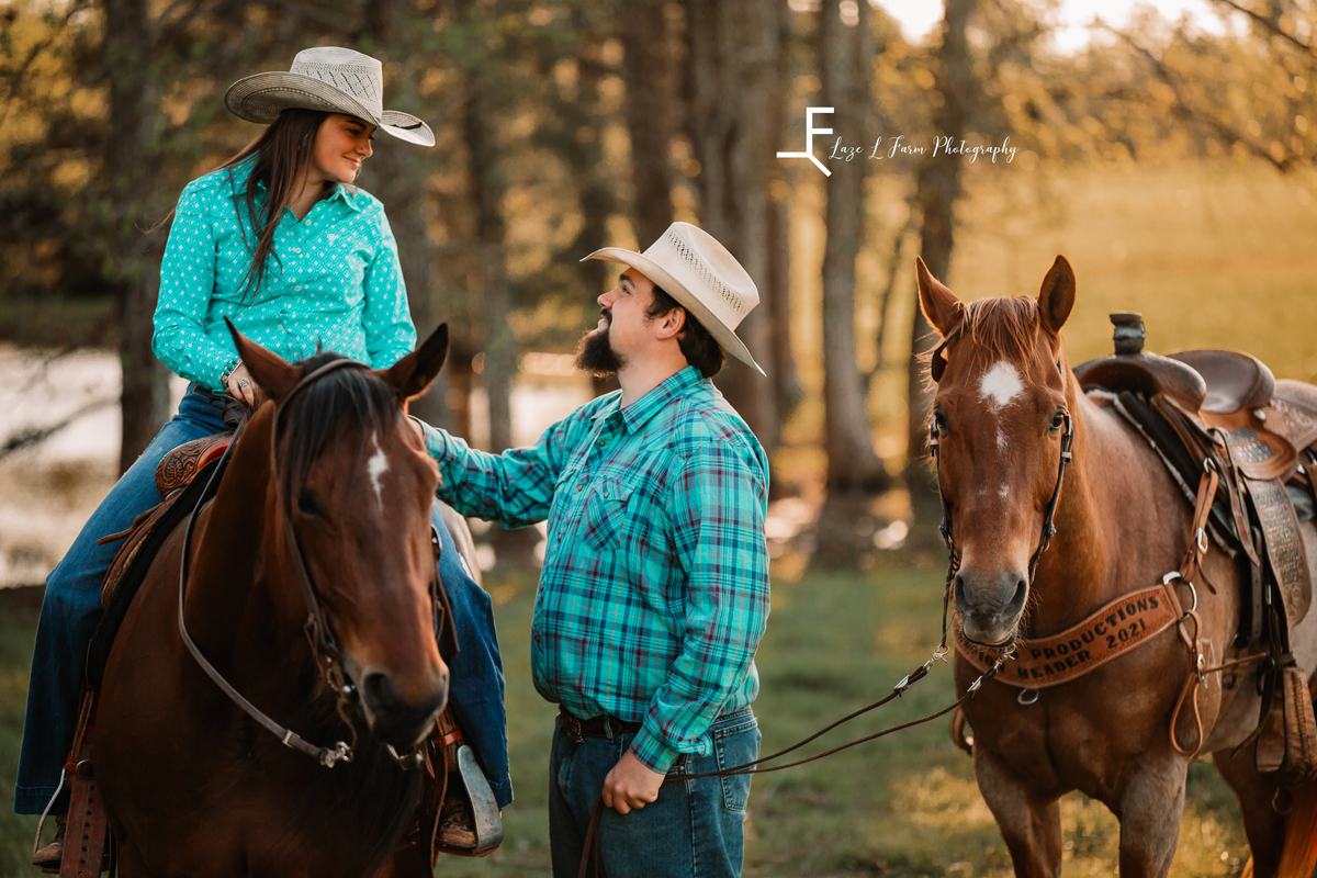 Laze L Farm Photography | Western Engagement Photoshoot | Cowpens SC | man looking up at his woman on the horse