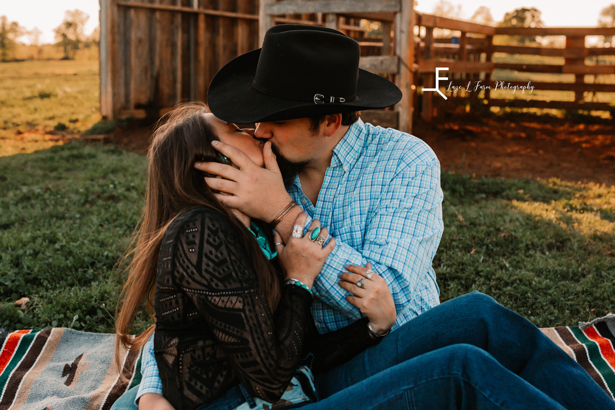 Laze L Farm Photography | Western Engagement Photoshoot | Cowpens SC | kissing sitting on the ground