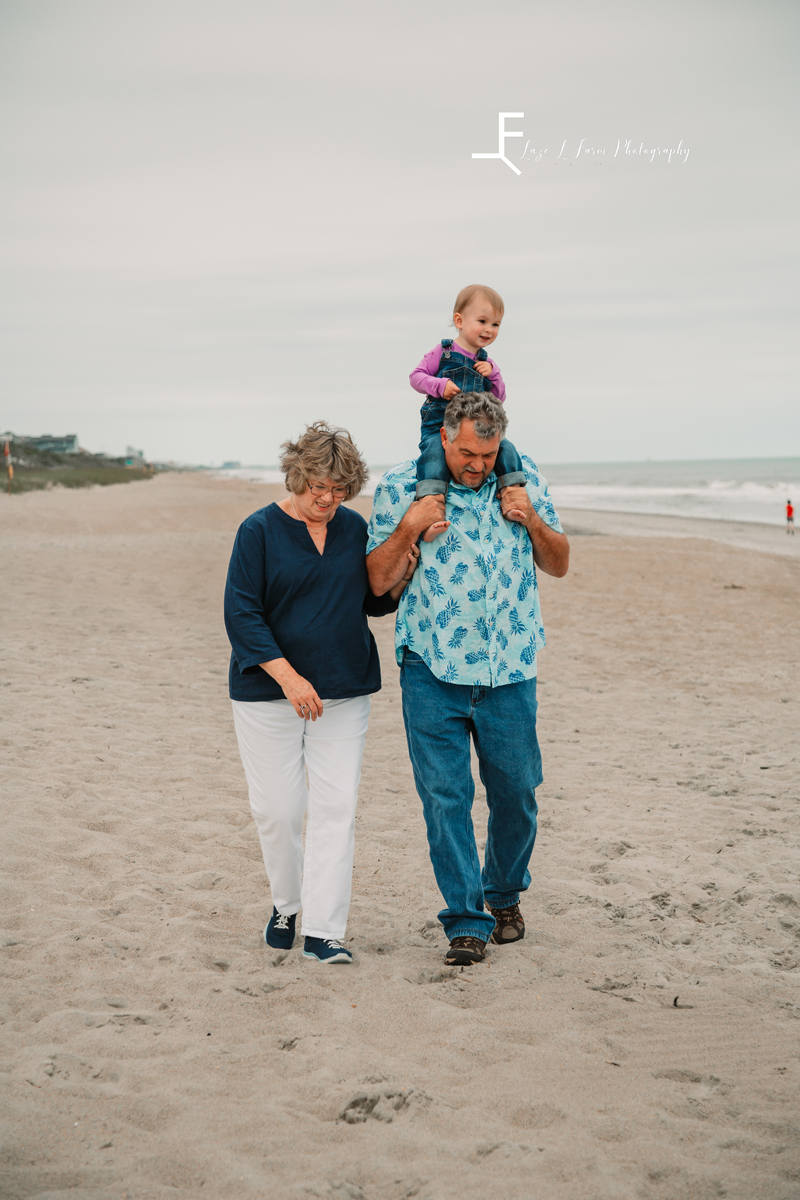 Laze L Farm Photography | Beach Trip | Emerald Isle NC | grandparents walking with lyza