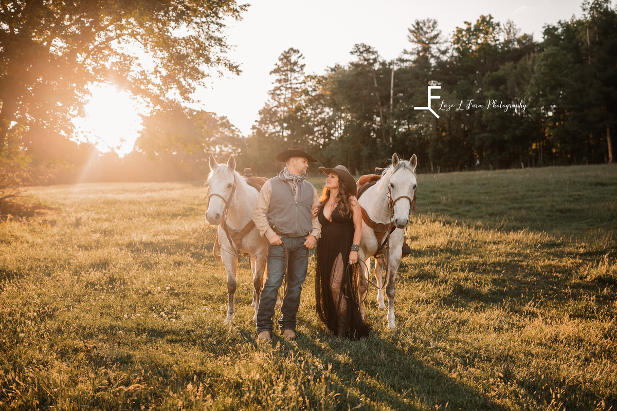 Laze L Farm Photography | Cowboy + Cowgirl Photoshoot | Dudley Shoals NC | couple posed next to their horses in a field