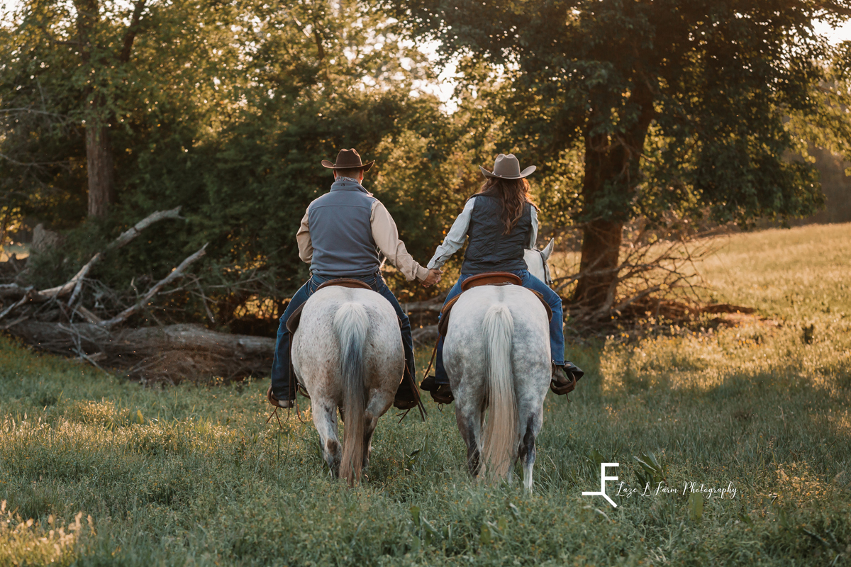 Laze L Farm Photography | Cowboy + Cowgirl Photoshoot | Dudley Shoals NC | couple riding horses together holding hands