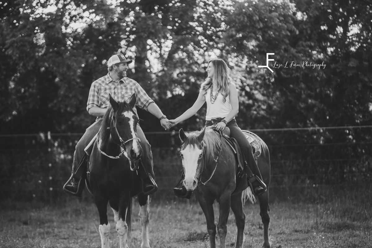 Laze L Farm Photography | Farm Session | Lincolnton NC | black and white of couple holding hands right horses