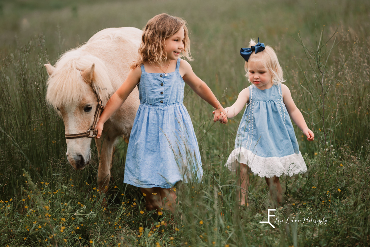 Laze L Farm Photography | Family Photographer | Taylorsville NC | daughters walking next to pony