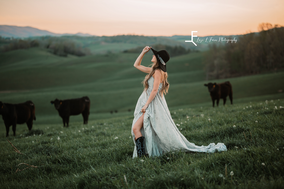 Laze L Farm Photography | Western Lifestyle Photoshoot | Wytheville Va | posing with cowboy hat wearing a dress in a field