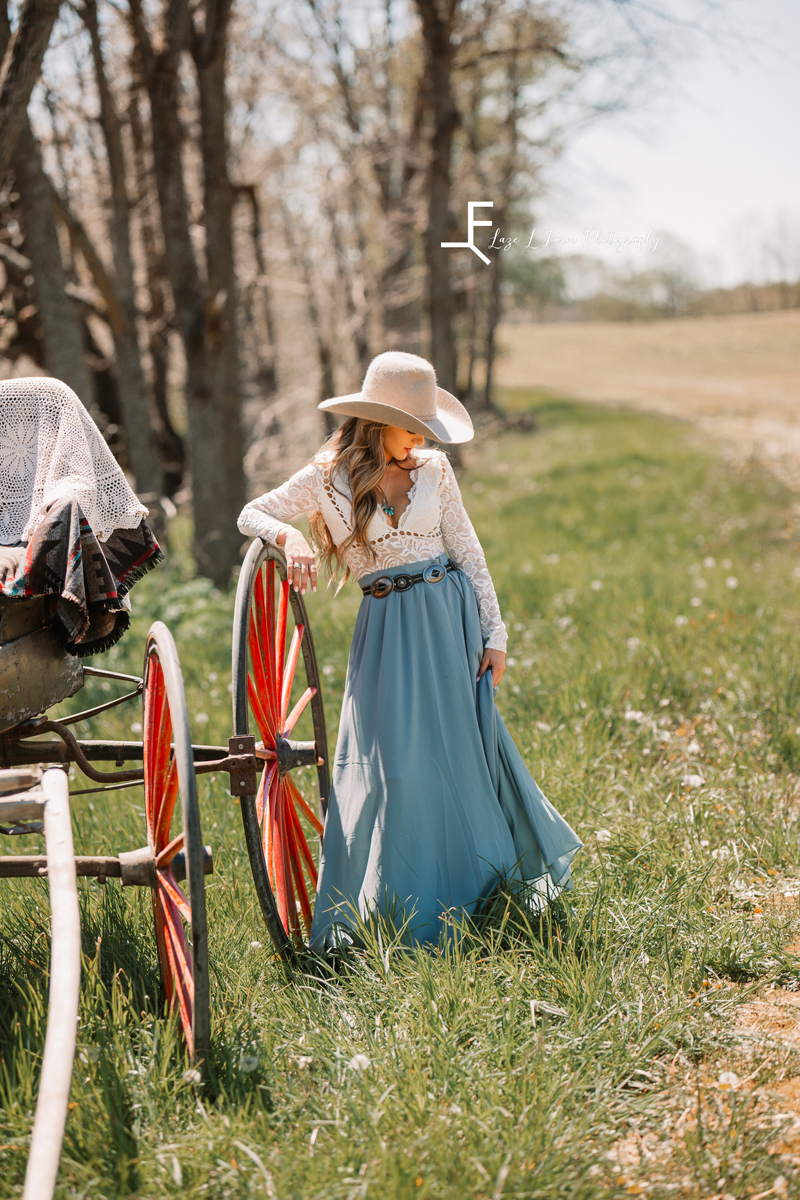 Laze L Farm Photography | Western Lifestyle Photoshoot | Wytheville Va | candid twirling the dress next to the carriage