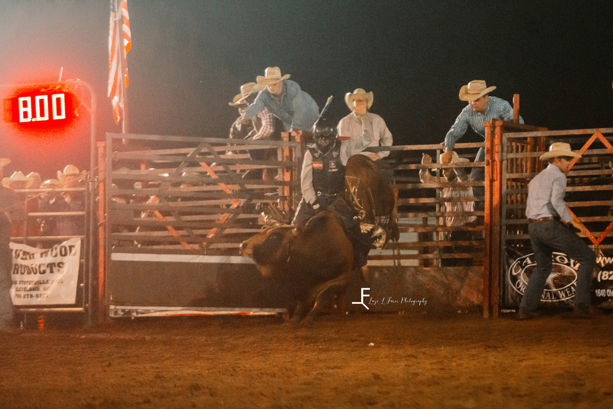 bull riding with brown bull and cowboy