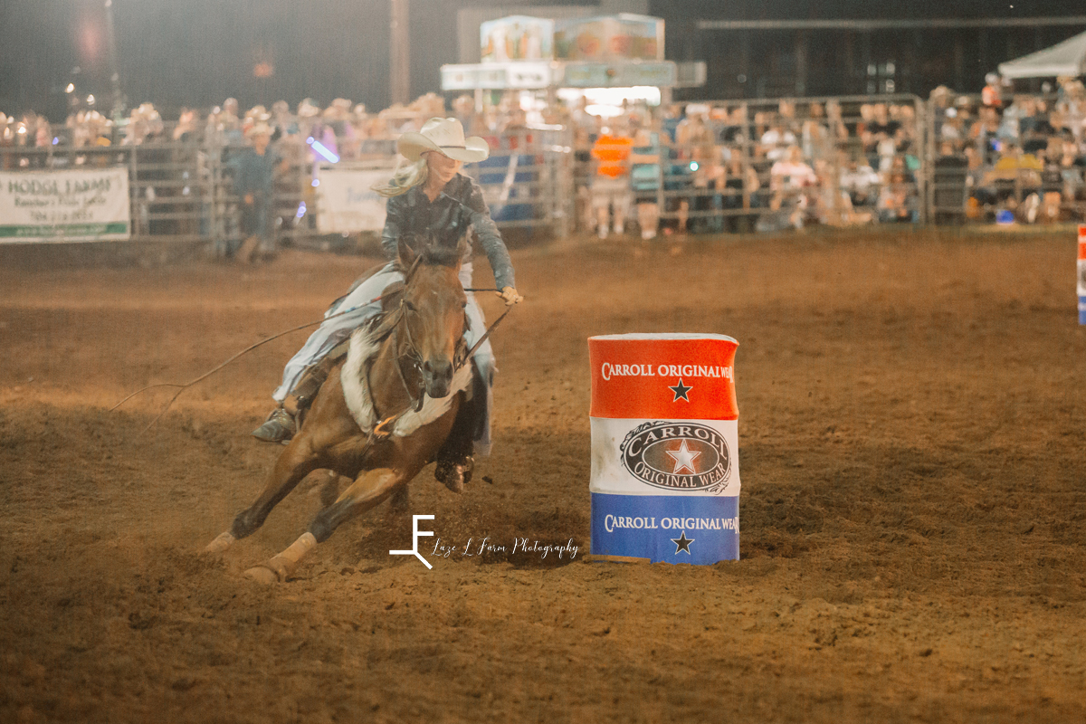 barrel racing cowgirl turning left
