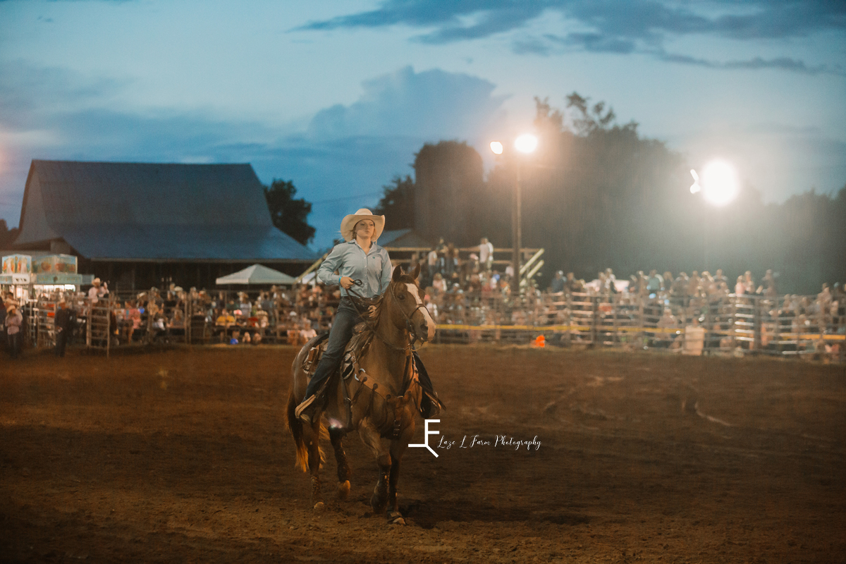 cowgirl pulling back horse