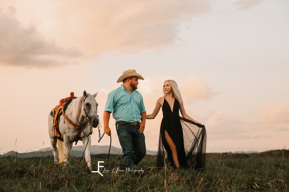 Laze L Farm Photography | Cowboy Couple | Taylorsville NC | couple walking alongside horse