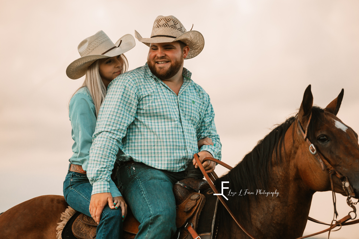 Laze L Farm Photography | Cowboy Couple | Taylorsville NC | couple lovingly look at each other while riding a horse