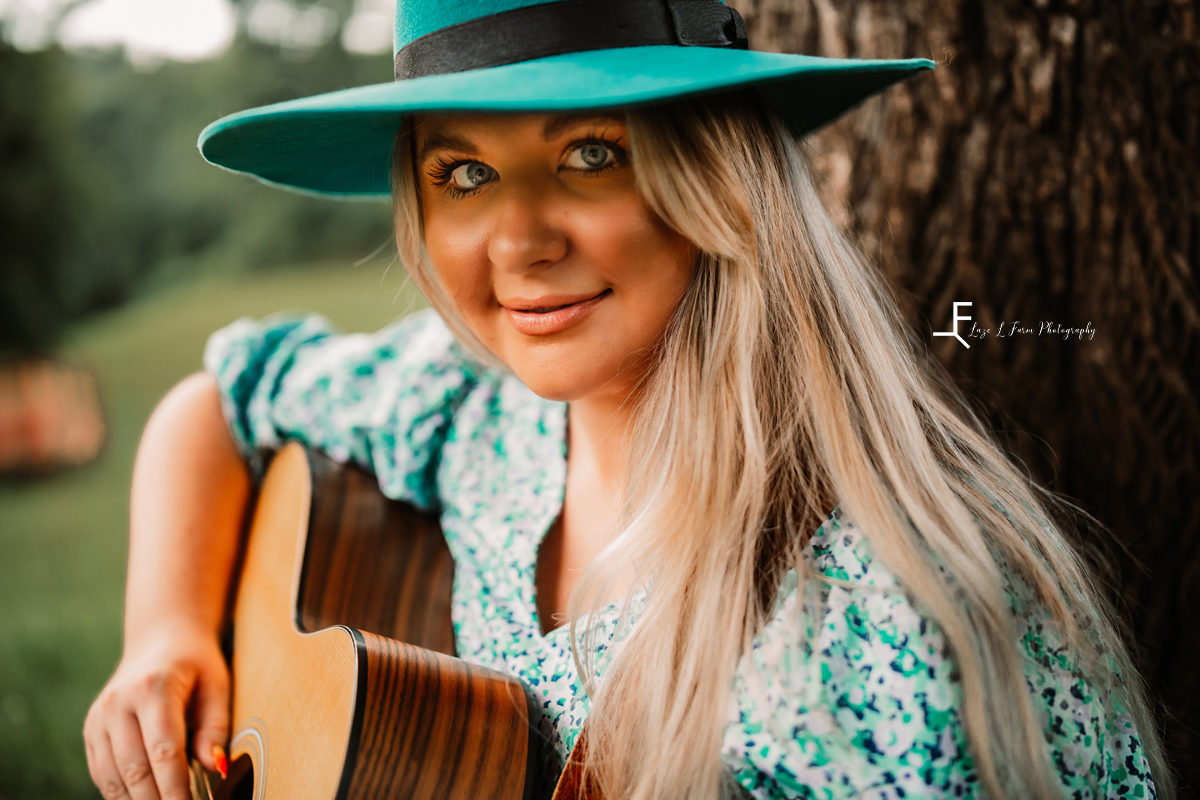 girl playing guitar with turquoise hat