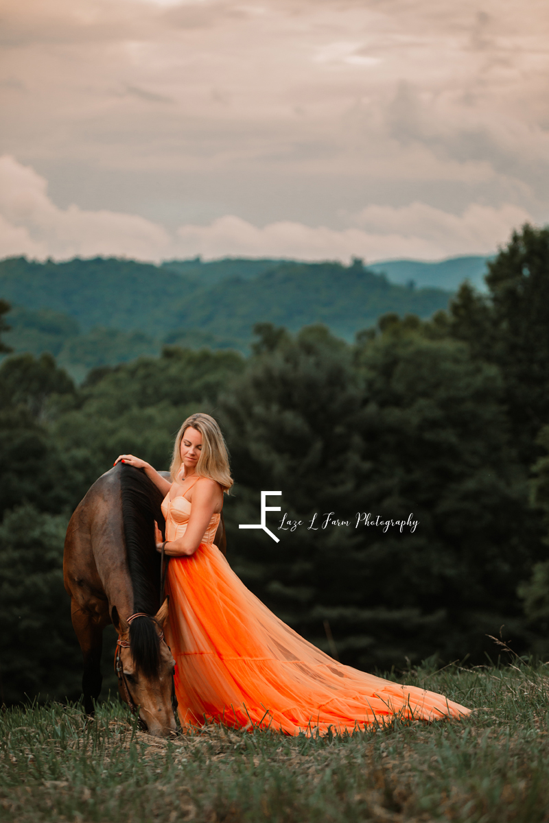 girl in orange dress with horse