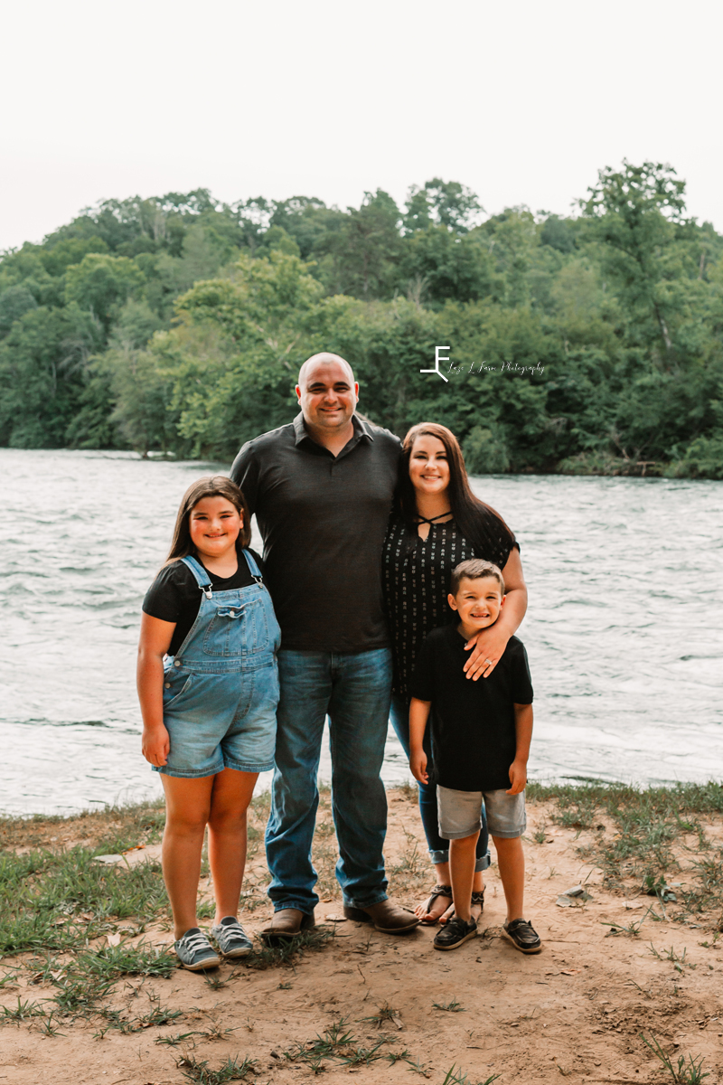 Parents with kids on river bank 