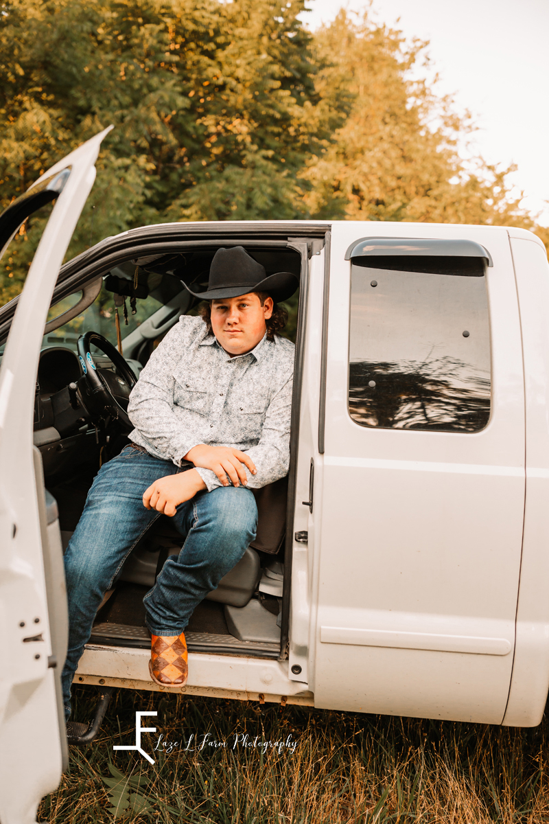 guy in truck sitting in driver's seat with cowboy hat