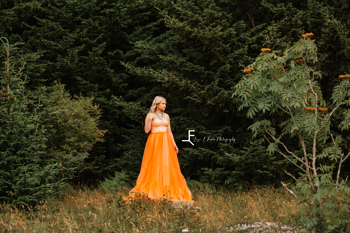 girl in orange dress in woods