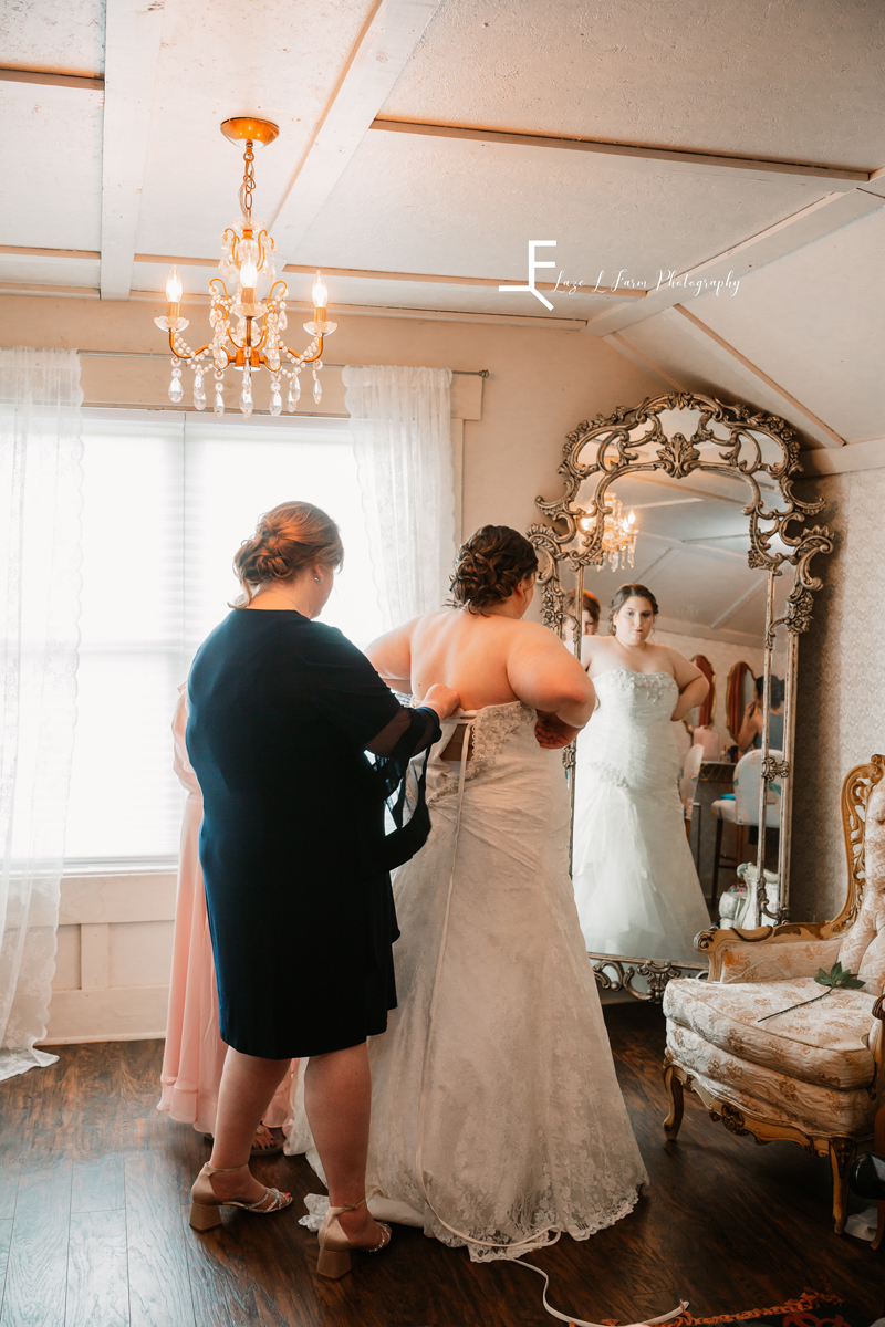 Laze L Farm Photography | Spring Wedding | Amity Creek Farms - Dudley Shoals NC | mother helping bride put on her dress