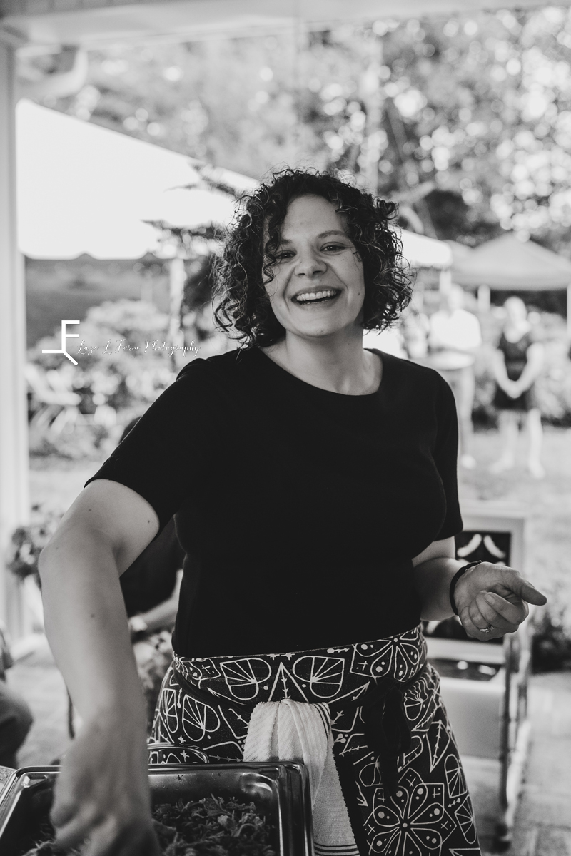 catering business owner checking the food with a smile