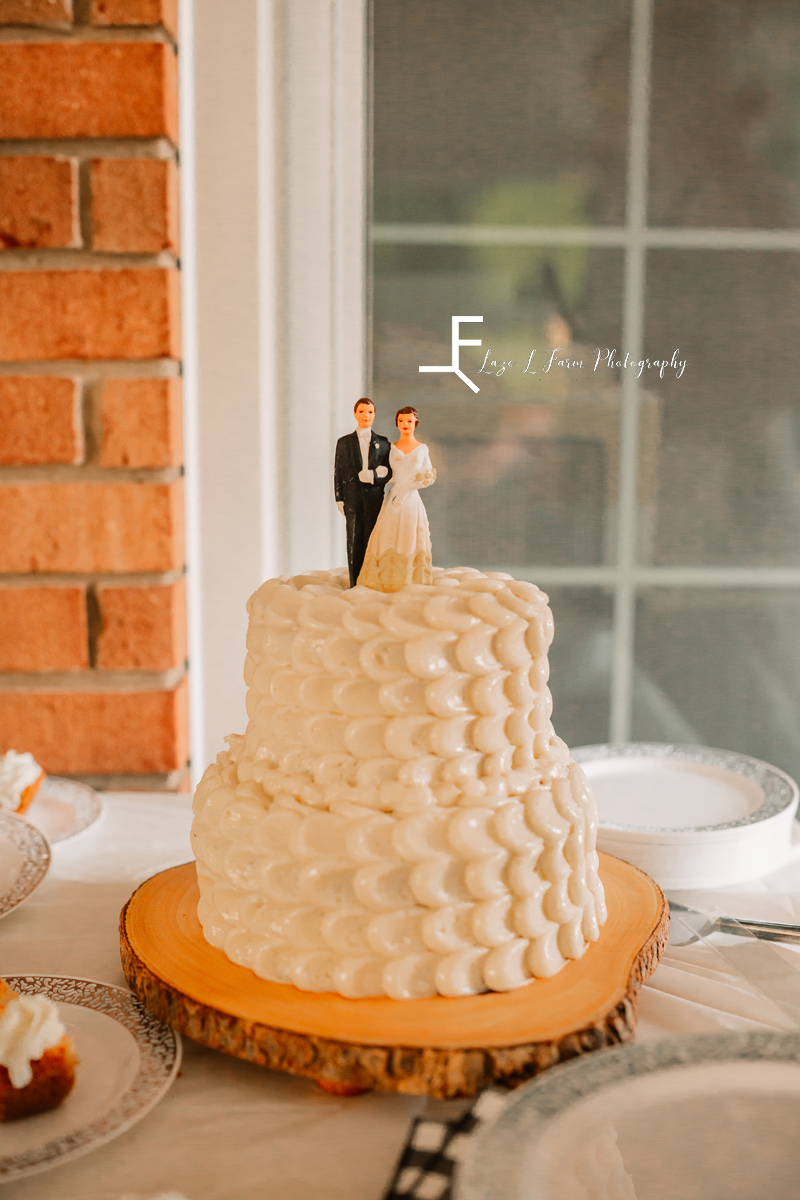 wedding cake with bride and groom figures on top