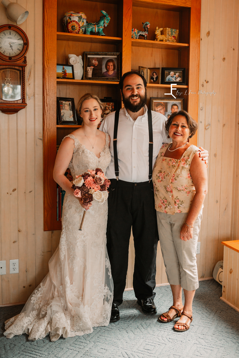 bride and groom with mother of the groo