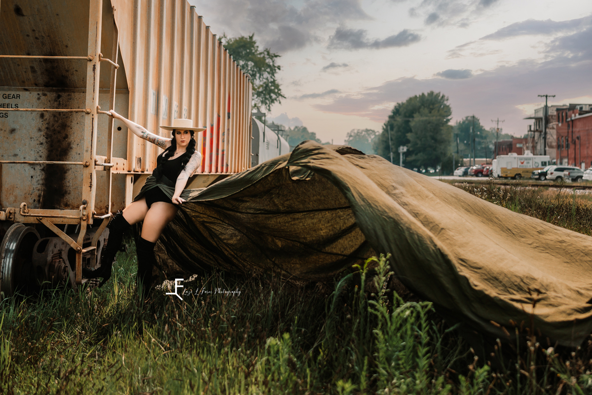 pregnant woman in parachute skirt leaning off train car