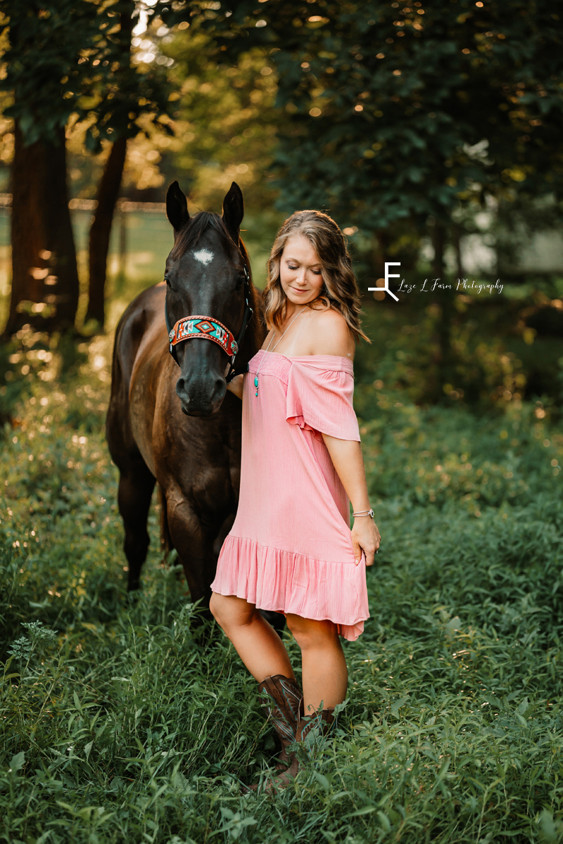 girl in pink dress with brown horse