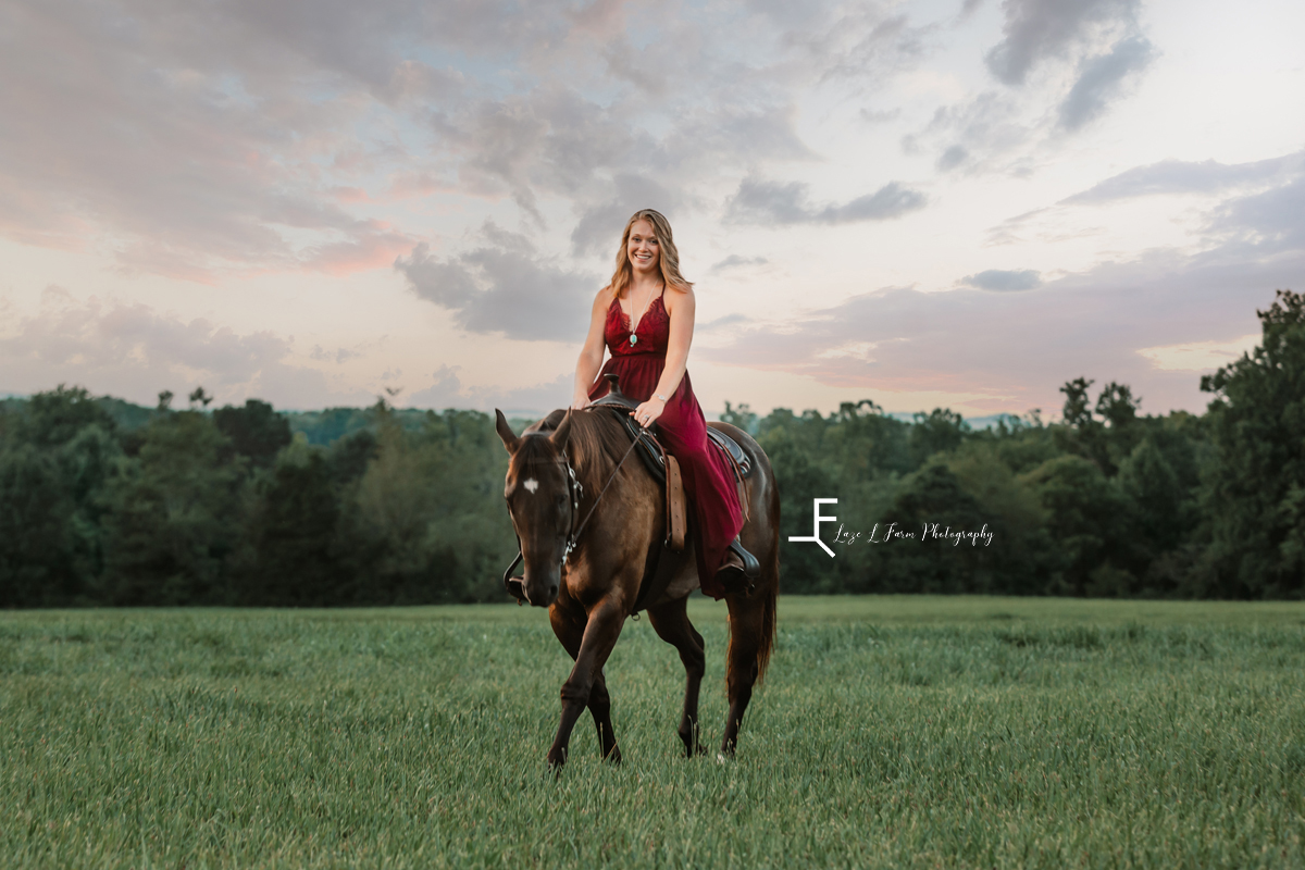 girl in red dress riding horse