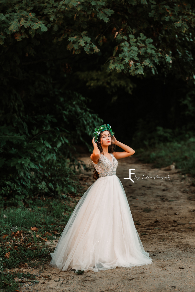 girl in white dress with greenery crown