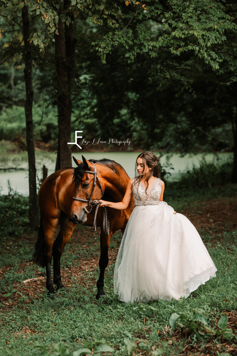 girl in white dress with horse looking left