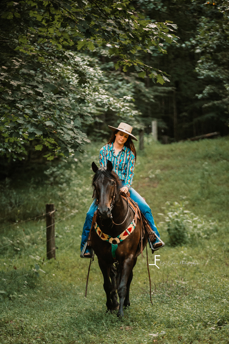 girl on black horse in field