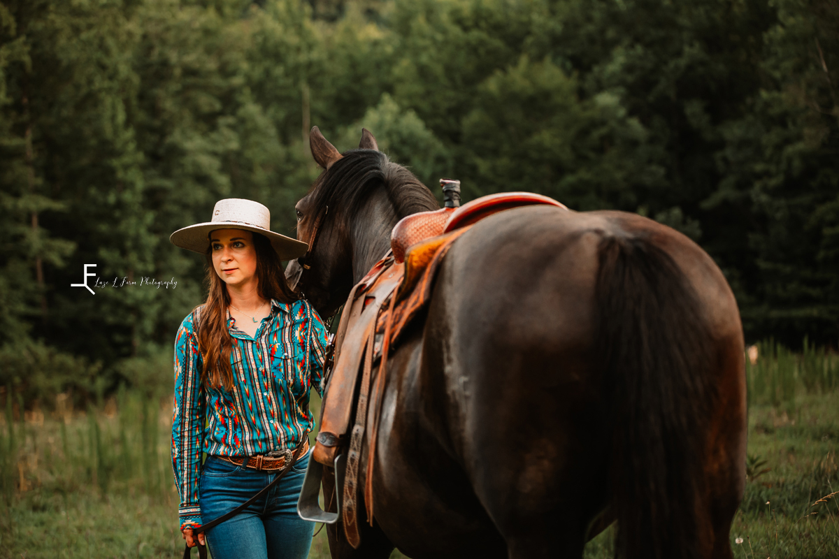 girl with black horse from behind the horse