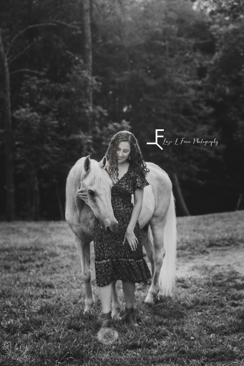 gray horse with girl in a sundress in black and white