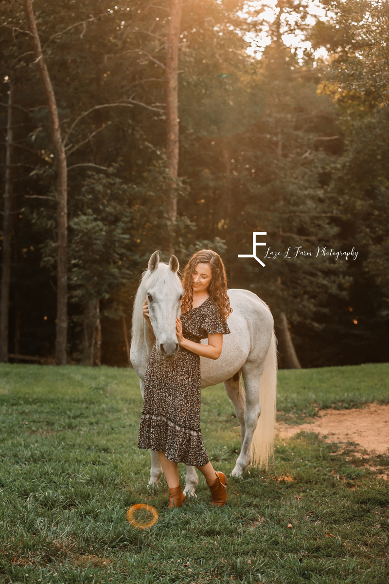 gray horse with girl in sundress looking at horse