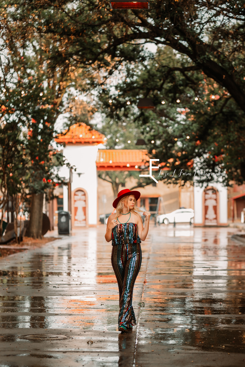 girl in sequin jumpsuit walking down street 
