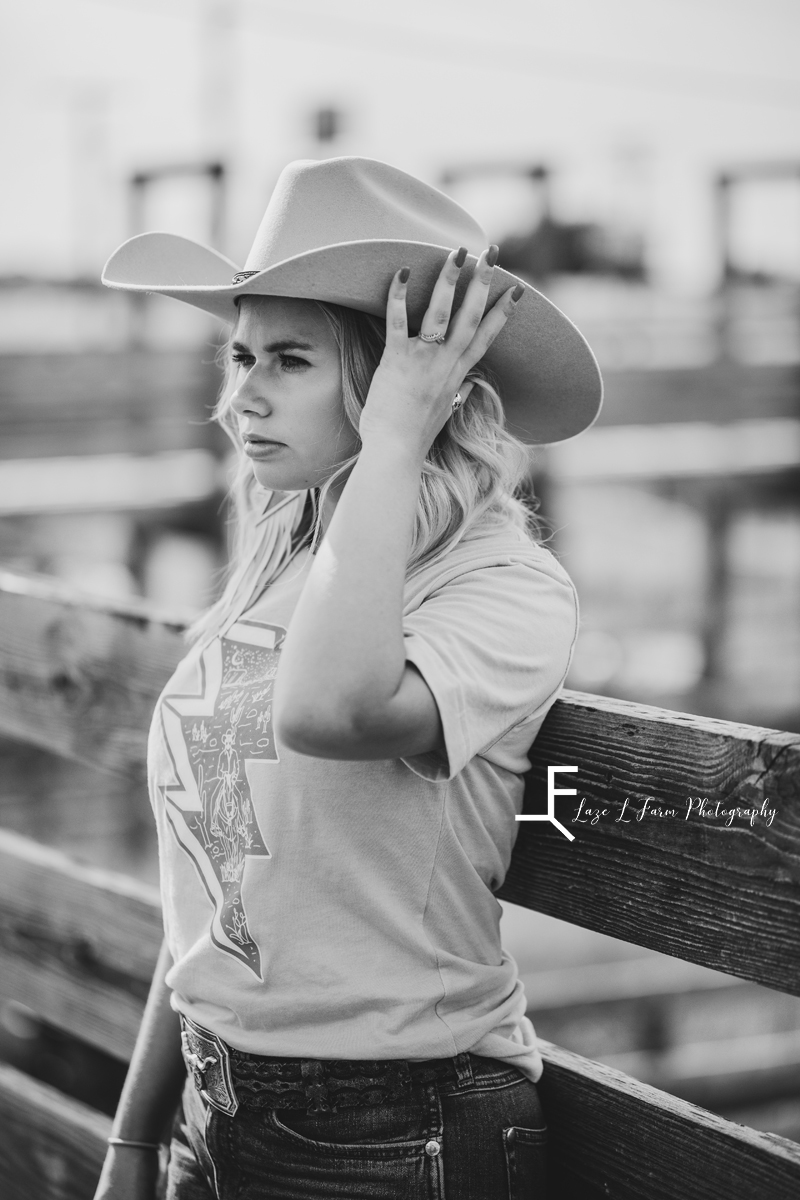 girl holding hat in stockyards black and white