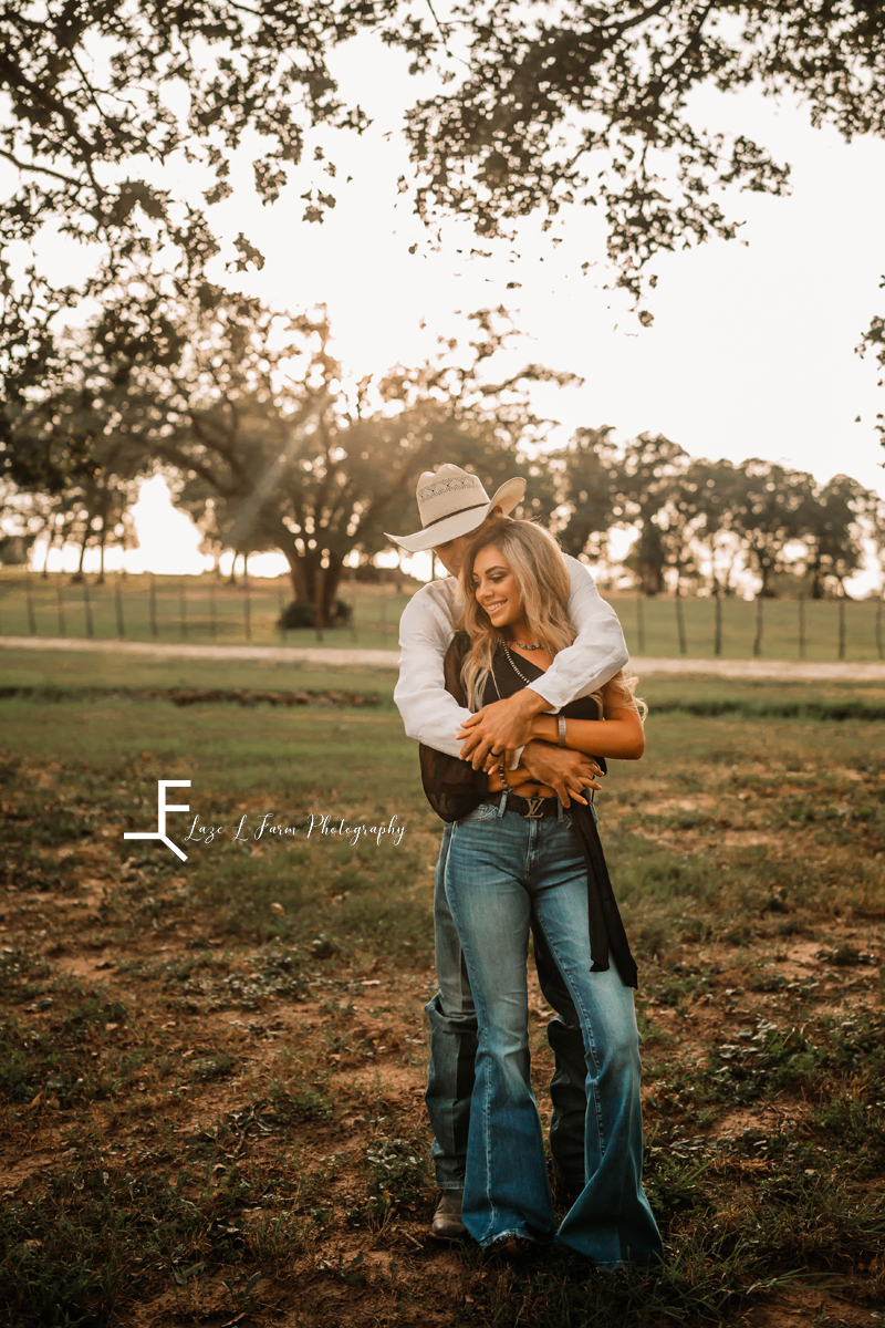 cowboy hugging wife from behind