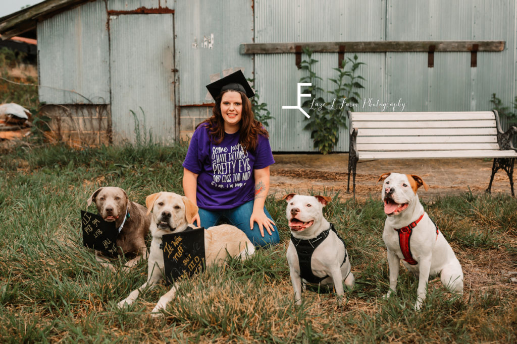 girl with graduate cap and 4 dogs