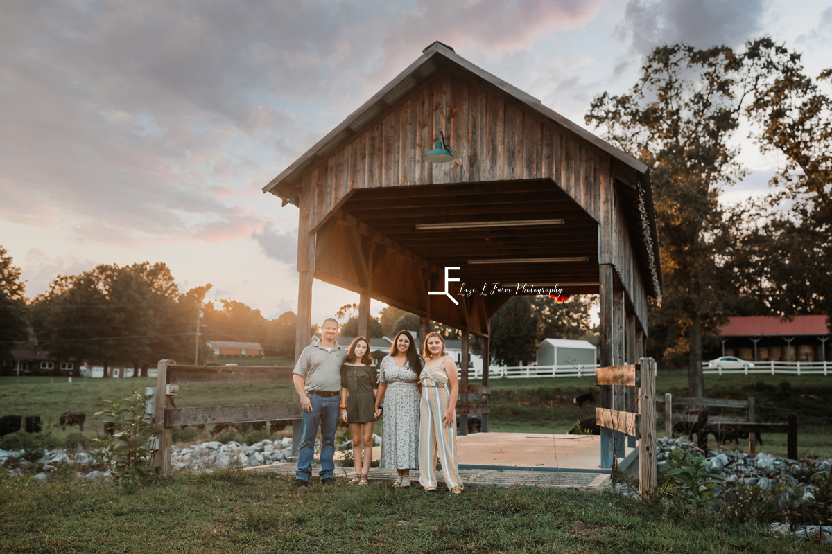 family at covered bridge at sunset