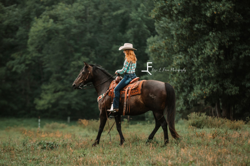 redhead girl riding black horse