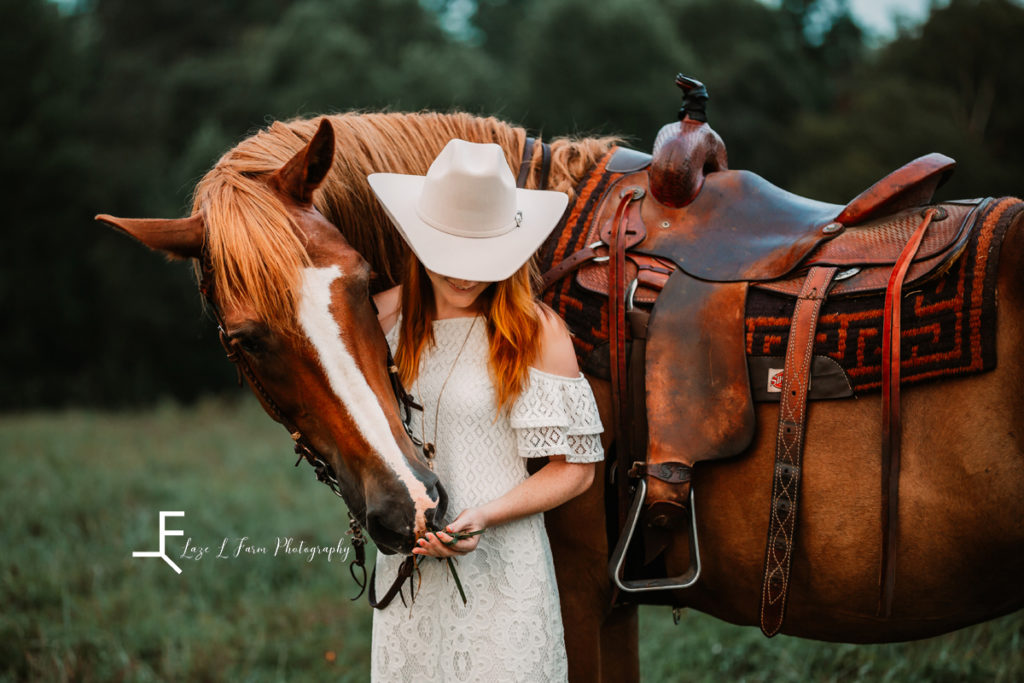 cowgirl with horses head around her
