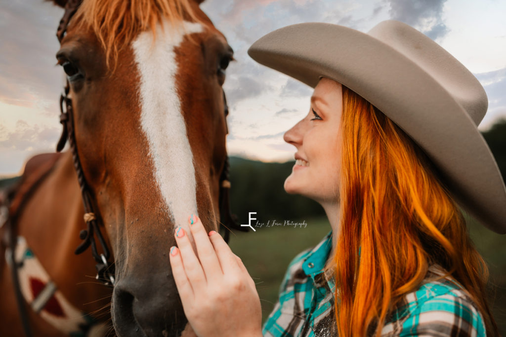 redhair cowgirl petting horse