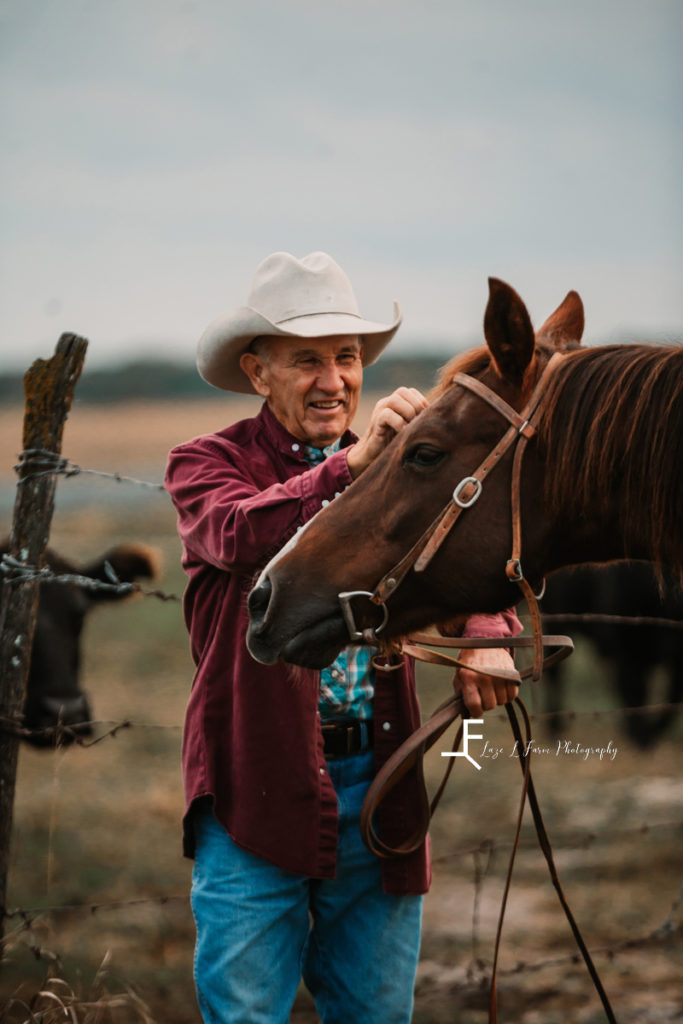 older cowboy loving his horse