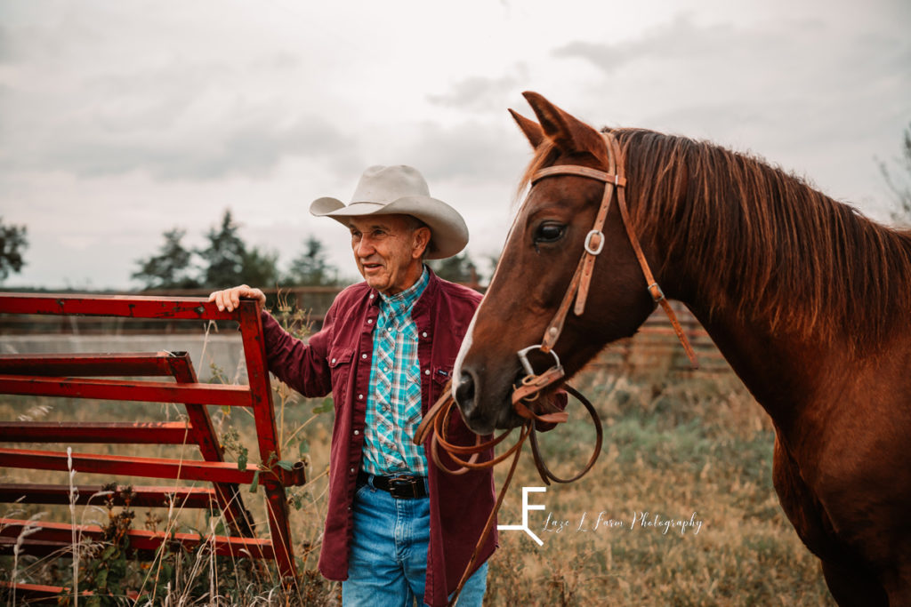 older cowboy with horse looking into distance
