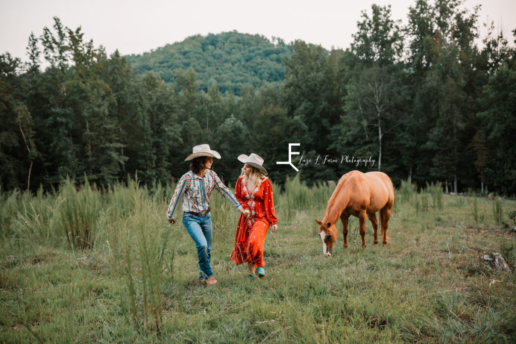 cowboy and cowgirl walking with horse