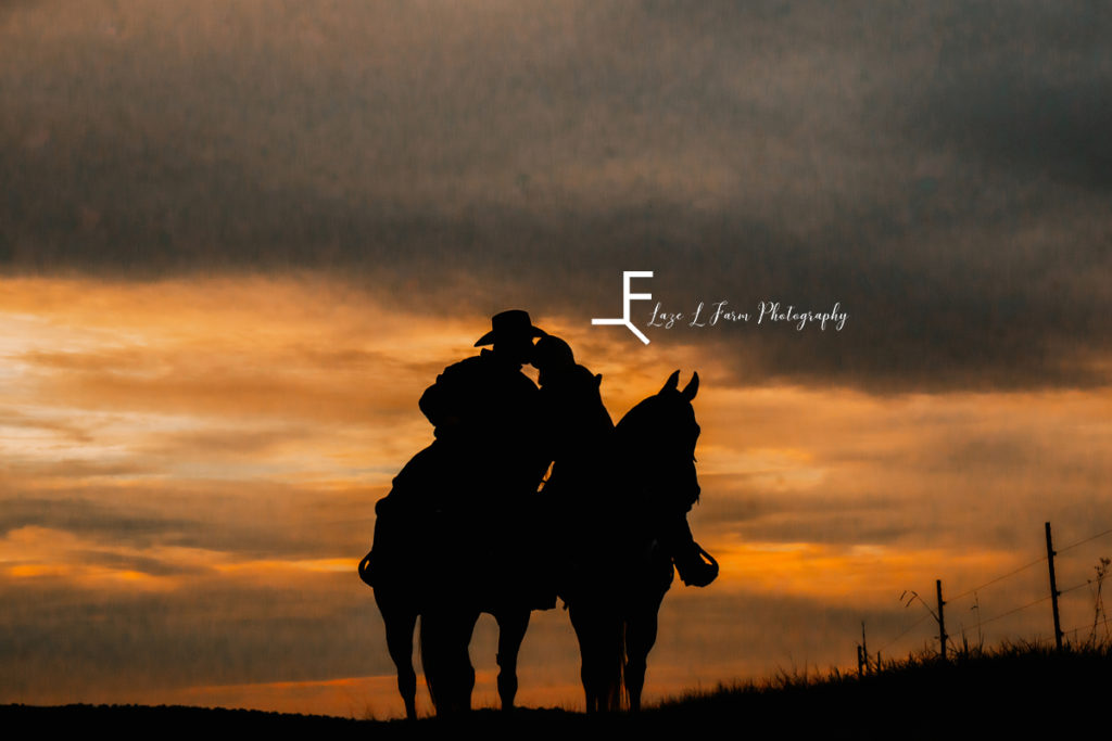 western couple kissing silhouette at sunset