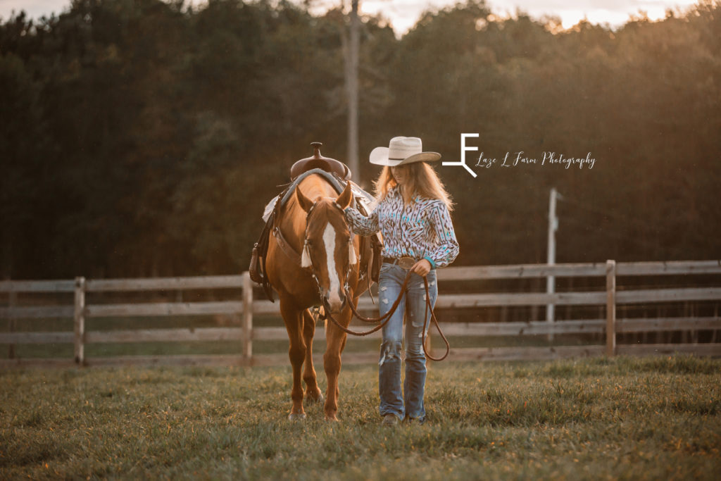 cowgirl walking with horse