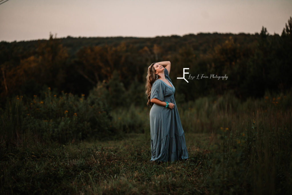 girl in blue dress looking up