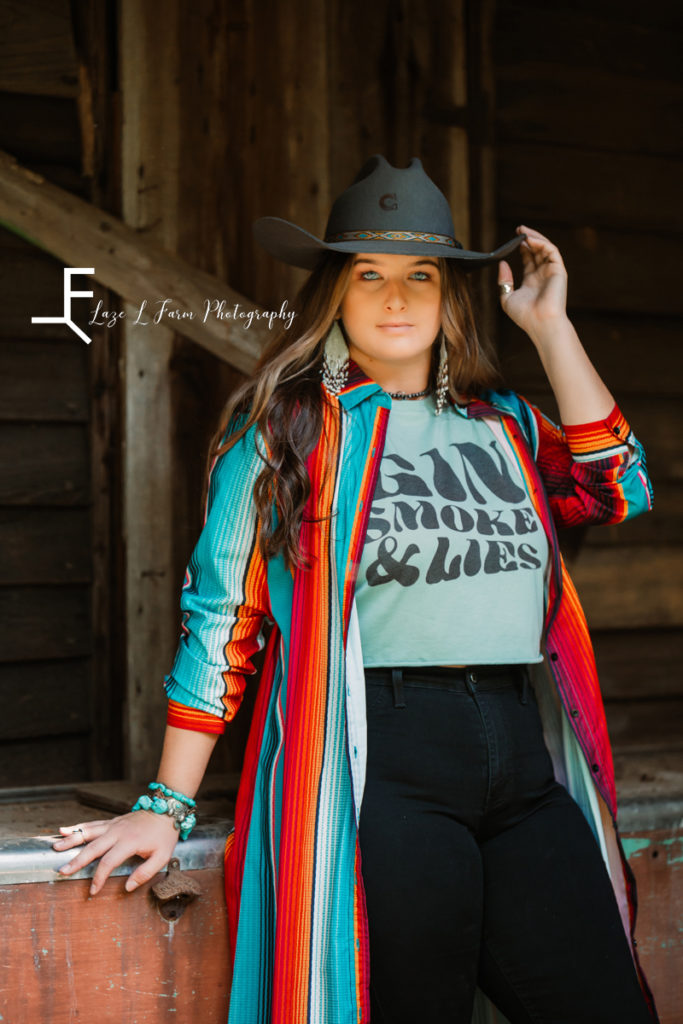 girl with serape print shirt and black hat