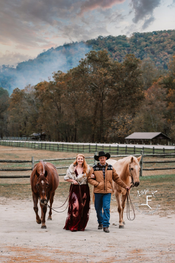 western couple with horses walkin