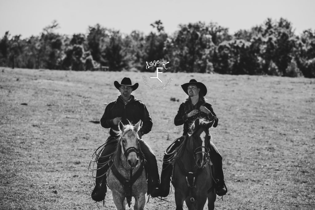 father and son cowboys in black and white